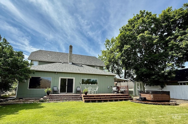 407 1st St, Asotin, WA 99402 - rear view of house with a hot tub, a wooden deck, a shingled roof, and a chimney