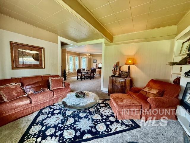 407 1st St, Asotin, WA 99402 - carpeted living area featuring a chandelier, crown molding, and beam ceiling