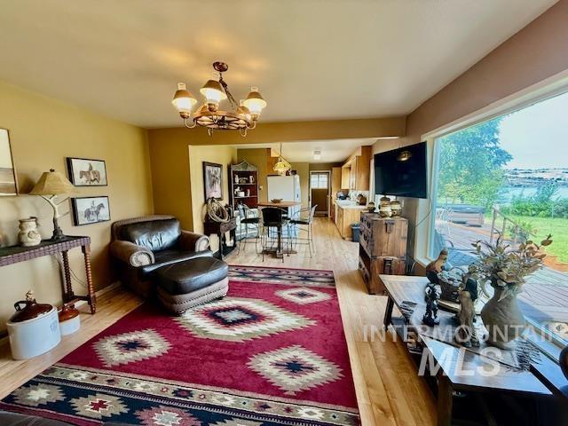 407 1st St, Asotin, WA 99402 - living area with a chandelier and light wood-style floors