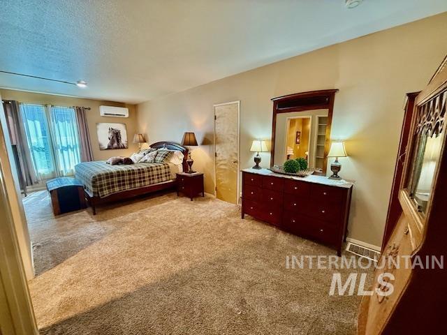407 1st St, Asotin, WA 99402 - carpeted bedroom with a wall mounted air conditioner