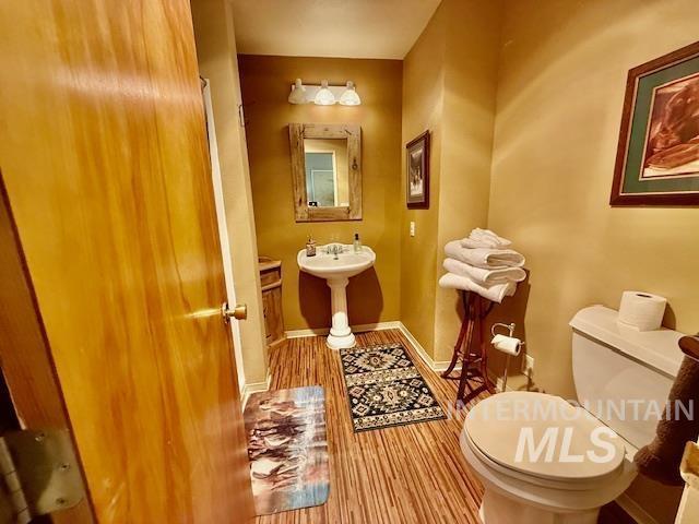 407 1st St, Asotin, WA 99402 - bathroom with toilet and wood finished floors
