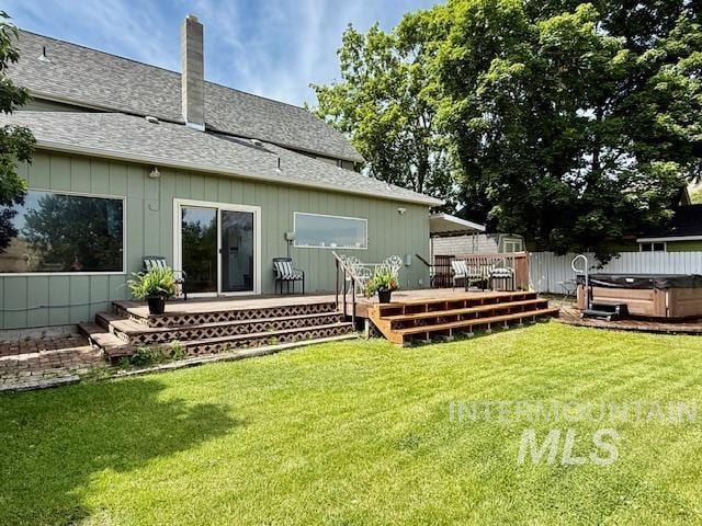 407 1st St, Asotin, WA 99402 - back of property with a hot tub, a shingled roof, a deck, and a chimney