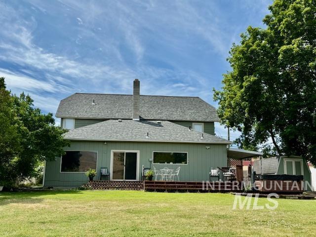407 1st St, Asotin, WA 99402 - back of property with a shingled roof, a yard, and a chimney