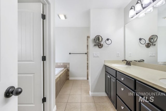 bathroom with a sink, a bath, double vanity, tile patterned flooring, and visible vents