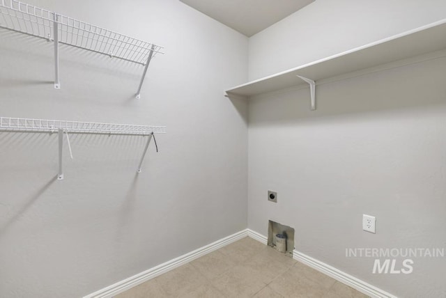 laundry area featuring baseboards, laundry area, and hookup for an electric dryer