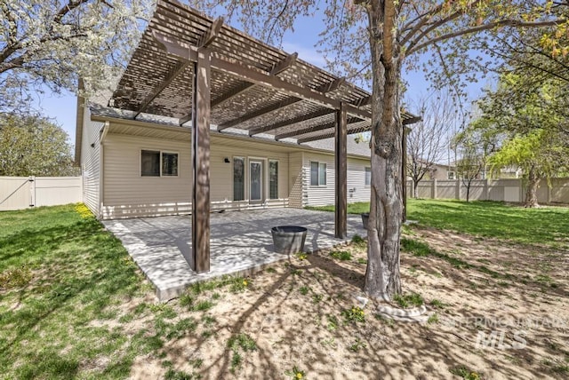back of house featuring a lawn, a pergola, fence, and a patio