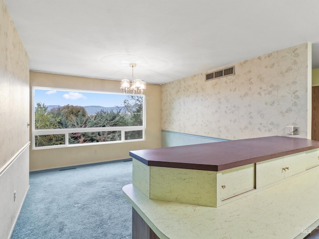 interior space with carpet and an inviting chandelier