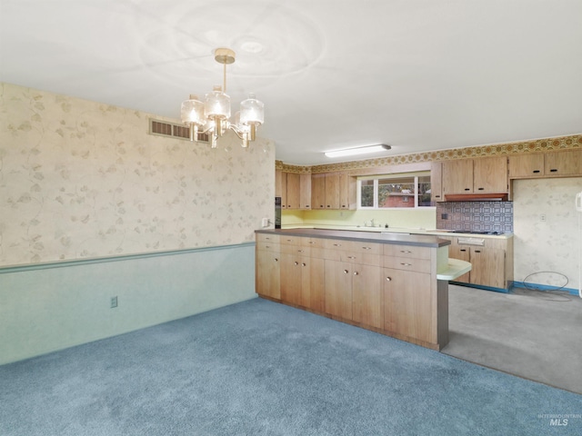 kitchen with light carpet, pendant lighting, and sink