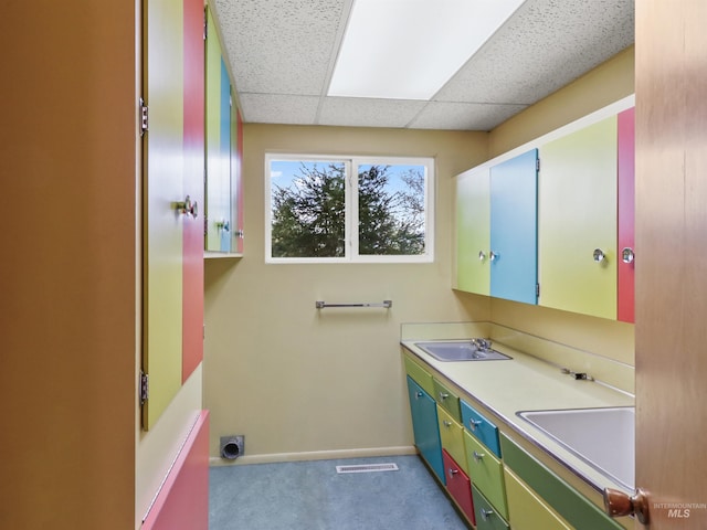 bathroom featuring vanity and a drop ceiling