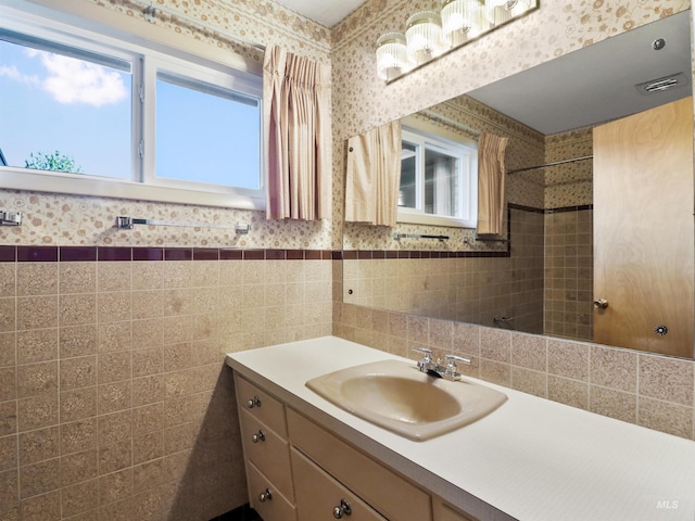 bathroom with tile walls and vanity