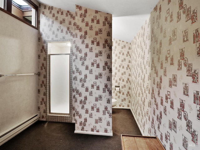 bathroom featuring baseboard heating and toilet