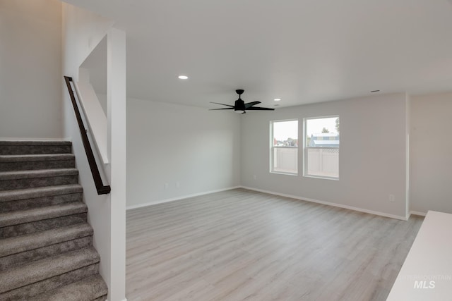 interior space with ceiling fan, light wood finished floors, stairway, and recessed lighting