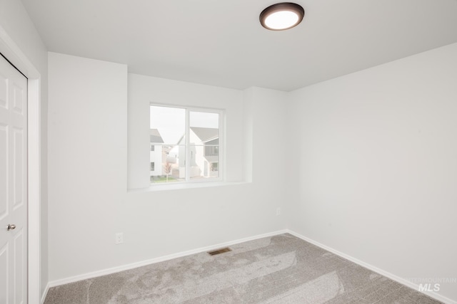 unfurnished bedroom featuring carpet floors, baseboards, and visible vents