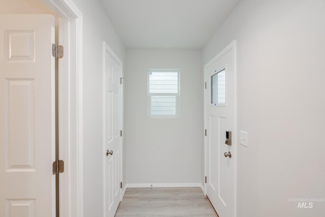 interior space featuring light wood finished floors and baseboards