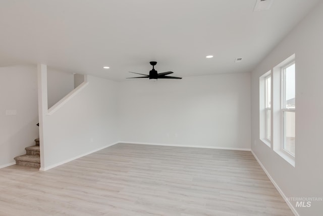 empty room featuring baseboards, stairway, and recessed lighting