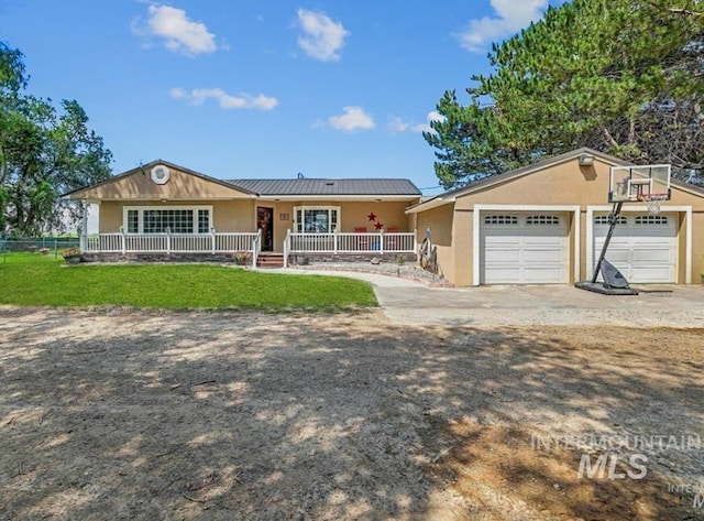 360 N 700 W, Paul, ID 83347 - ranch-style house with a porch, stucco siding, a garage, driveway, and metal roof