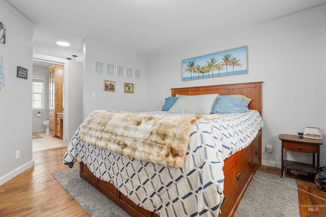 360 N 700 W, Paul, ID 83347 - bedroom featuring light wood-style floors, baseboards, and ensuite bath
