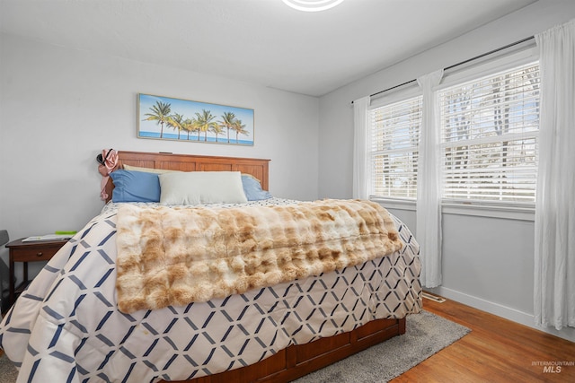 360 N 700 W, Paul, ID 83347 - bedroom with wood finished floors, multiple windows, and baseboards