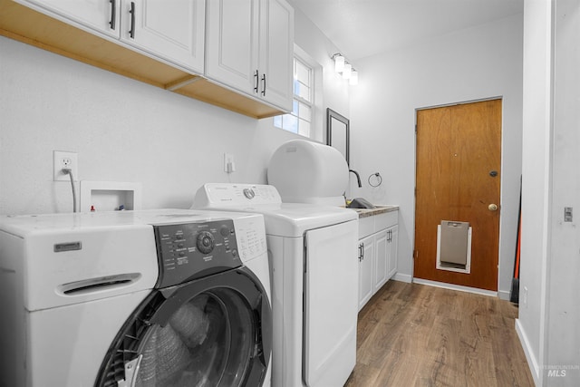360 N 700 W, Paul, ID 83347 - laundry room featuring cabinet space, wood finished floors, washing machine and clothes dryer, and baseboards