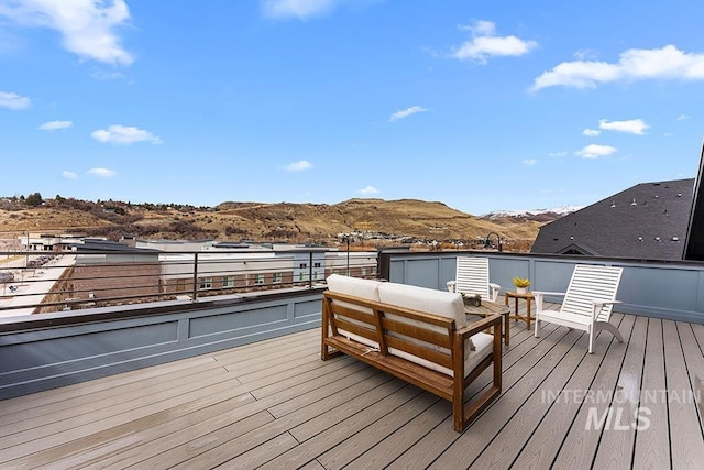 deck with a mountain view and an outdoor hangout area