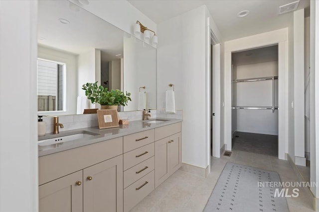 4265 W Thornapple Dr, Meridian, ID 83646 - full bath featuring tile patterned flooring, double vanity, tasteful backsplash, and baseboards