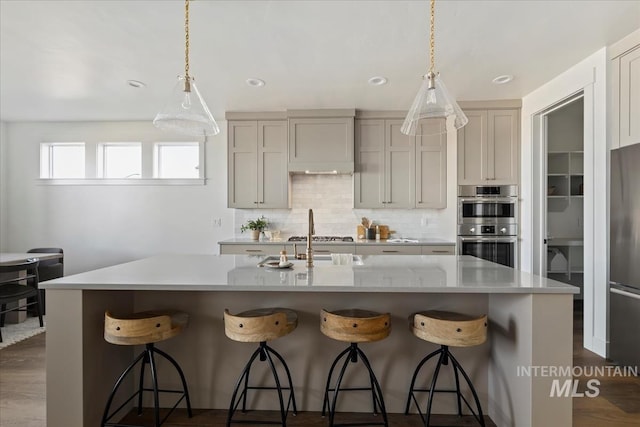 4265 W Thornapple Dr, Meridian, ID 83646 - kitchen with light countertops, stainless steel appliances, backsplash, a breakfast bar, and recessed lighting