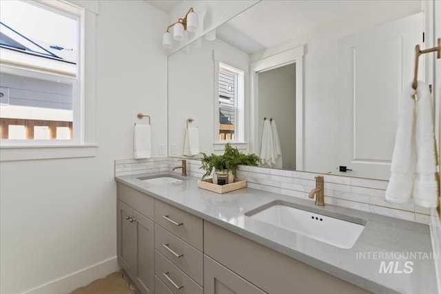 4265 W Thornapple Dr, Meridian, ID 83646 - full bathroom featuring backsplash, double vanity, and baseboards
