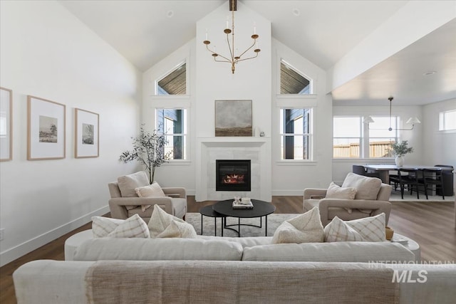 4265 W Thornapple Dr, Meridian, ID 83646 - living room featuring a chandelier, high vaulted ceiling, a tile fireplace, dark wood-style floors, and baseboards