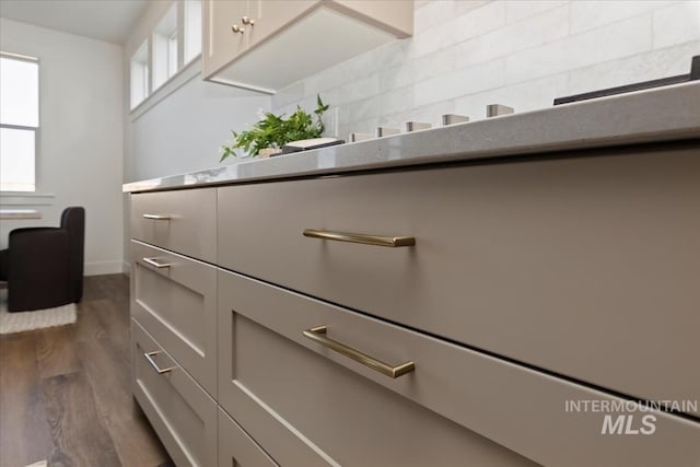 4265 W Thornapple Dr, Meridian, ID 83646 - kitchen view of dark wood-style floors, decorative backsplash, and baseboards