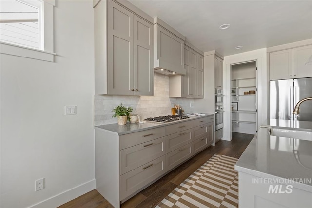 4265 W Thornapple Dr, Meridian, ID 83646 - kitchen with appliances with stainless steel finishes, light countertops, backsplash, dark wood-type flooring, and a sink