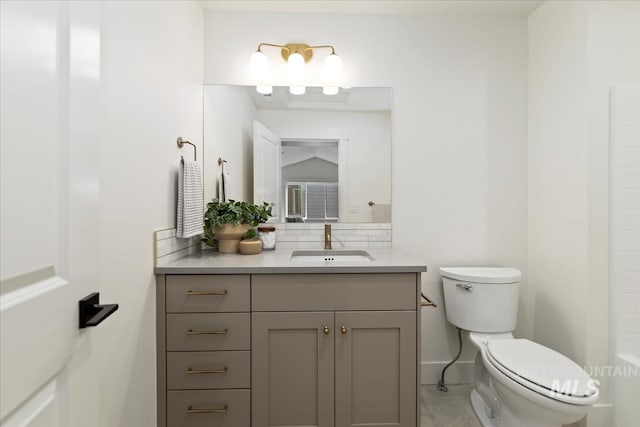 4265 W Thornapple Dr, Meridian, ID 83646 - bathroom with toilet, vanity, tile patterned flooring, and backsplash