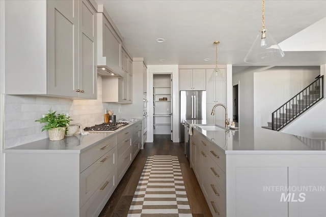 4265 W Thornapple Dr, Meridian, ID 83646 - kitchen featuring a sink, light countertops, dark wood-style floors, backsplash, and appliances with stainless steel finishes