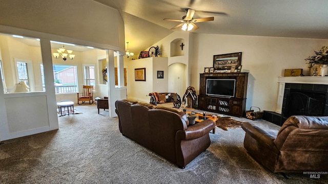 living room with carpet, lofted ceiling, ceiling fan with notable chandelier, and a tile fireplace