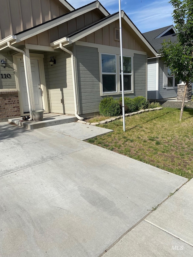 110 W Yosemite St, Meridian, ID 83646 - entrance to property with board and batten siding and a yard