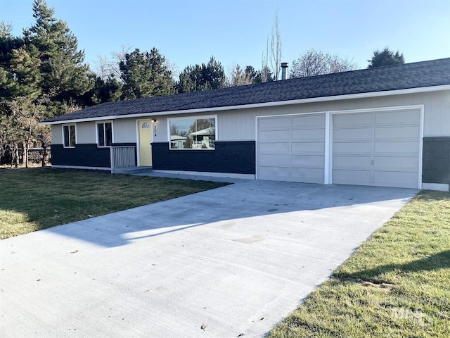 ranch-style home featuring a garage, a front yard, and concrete driveway