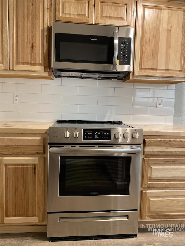 kitchen featuring light brown cabinets, tasteful backsplash, appliances with stainless steel finishes, and light countertops