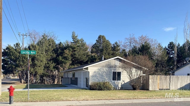 view of side of property featuring a yard and fence