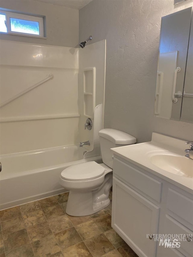 full bath featuring a textured wall, shower / bath combination, vanity, and toilet