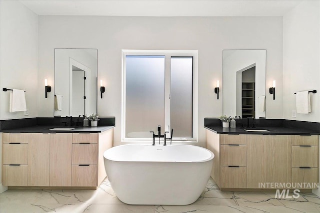 bathroom featuring vanity and a tub to relax in