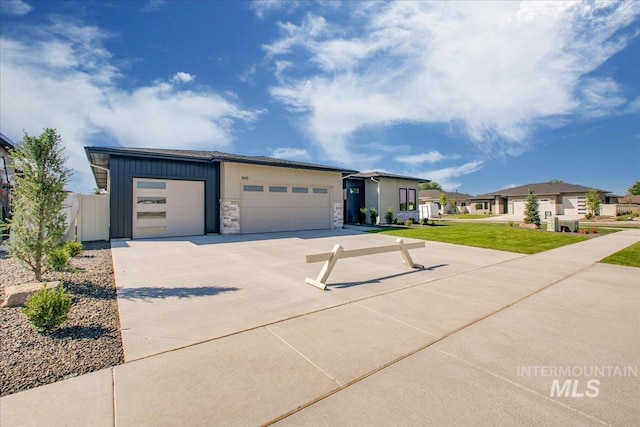 view of front of property with a front yard and a garage