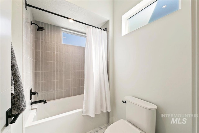 bathroom with toilet and shower / tub combo