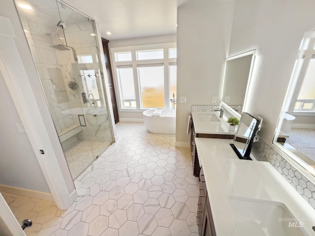 7063 S Pear Blossom, Meridian, ID 83642 - bathroom featuring baseboards, a freestanding tub, a sink, double vanity, and a stall shower