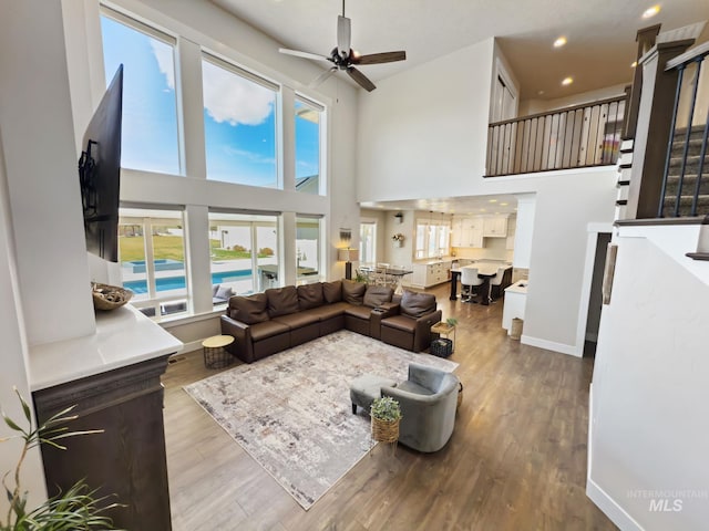 7063 S Pear Blossom, Meridian, ID 83642 - living room featuring ceiling fan, recessed lighting, a high ceiling, wood finished floors, and baseboards