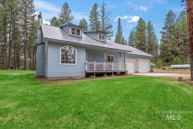42 Hiatt Cir, Idaho City, ID 83631 - view of front facade featuring covered porch, a garage, a front yard, metal roof, and driveway