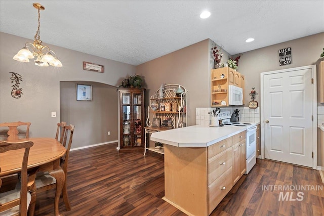 42 Hiatt Cir, Idaho City, ID 83631 - kitchen with white appliances, arched walkways, open shelves, dark wood-style flooring, and a textured ceiling