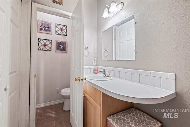 42 Hiatt Cir, Idaho City, ID 83631 - bathroom featuring toilet, tile patterned flooring, vanity, and tasteful backsplash