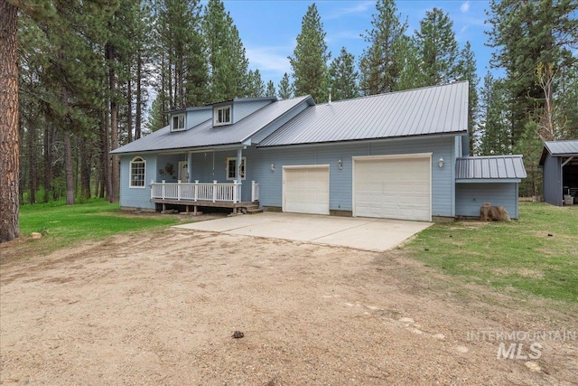 42 Hiatt Cir, Idaho City, ID 83631 - view of front of property featuring driveway, an attached garage, a porch, metal roof, and a front yard
