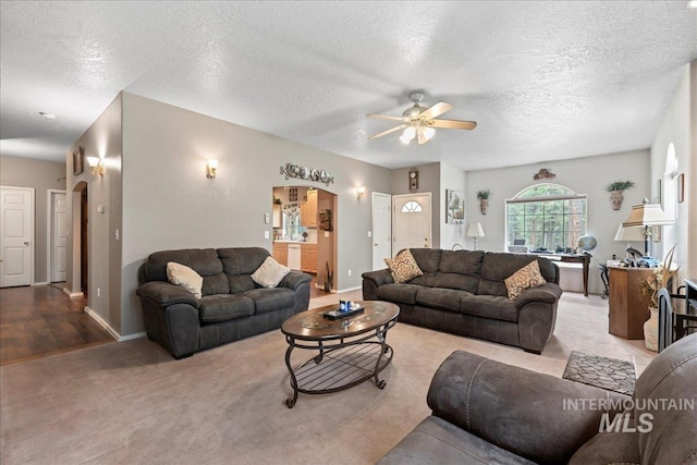 42 Hiatt Cir, Idaho City, ID 83631 - carpeted living room with arched walkways, ceiling fan, baseboards, and a textured ceiling