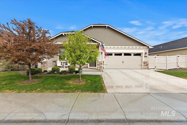 view of front facade featuring a garage, a front yard, stone siding, and concrete driveway