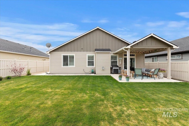 back of property featuring board and batten siding, an outdoor living space, a lawn, a fenced backyard, and a patio